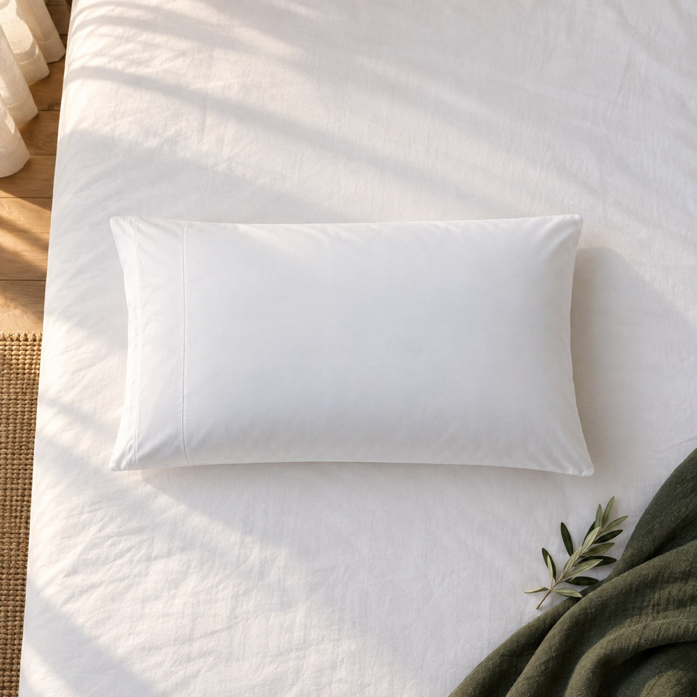 The Huxberry ActivChill Pillow Protector from above with a green linen throw