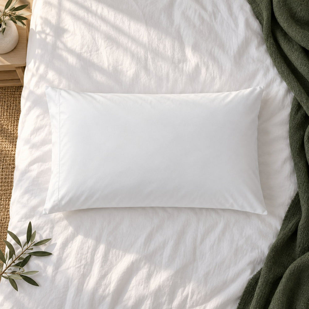 The Huxberry ActivGuard Pillow Protector from above with a green linen throw