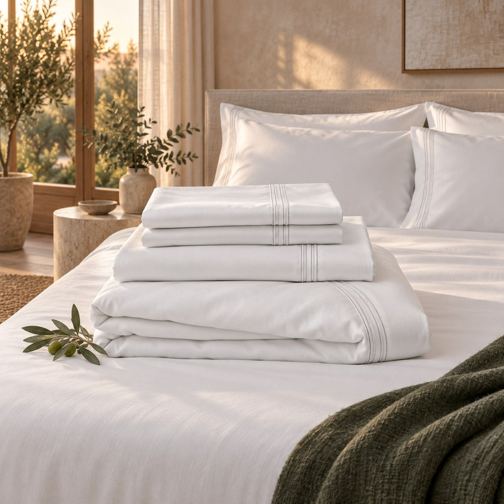 The Huxberry Essence Tencel Bedding Bundle neatly folded on a made bed