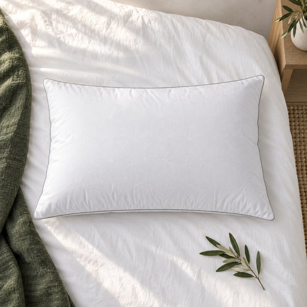 Huxberry Frosted Ice Pillow from above on white cotton sheets with a green linen throw