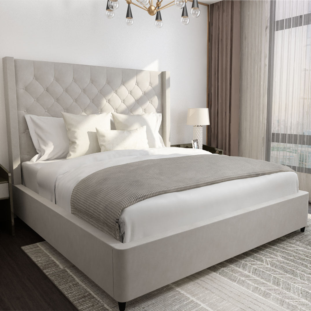 An upholstered Huxberry bed made up with soft grey bedding