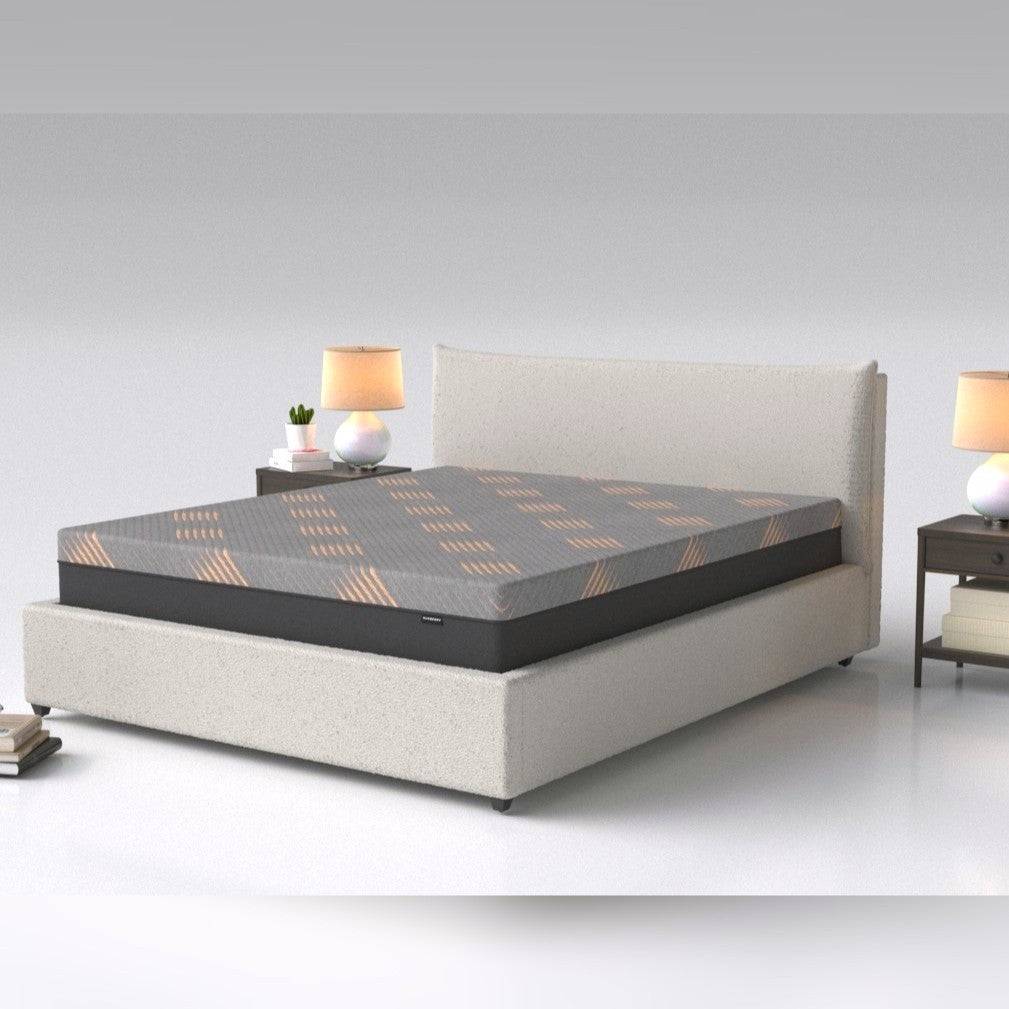 A modern upholstered bed with a padded headboard and a mattress with a geometric pattern, in a minimalistic bedroom setting.