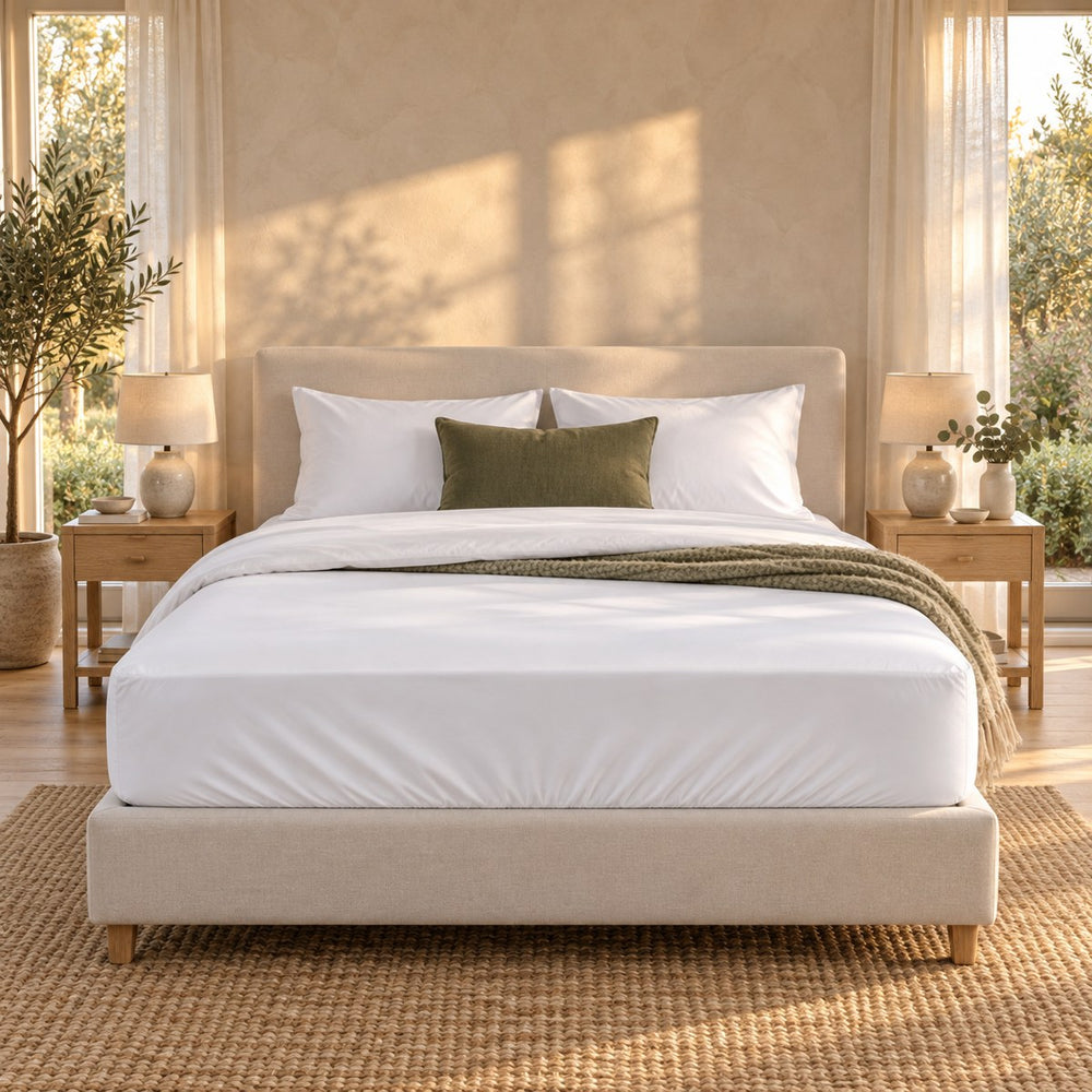 The Huxberry ActivChill 5-Sided Mattress Protector on a bed, seen straight on from the foot
