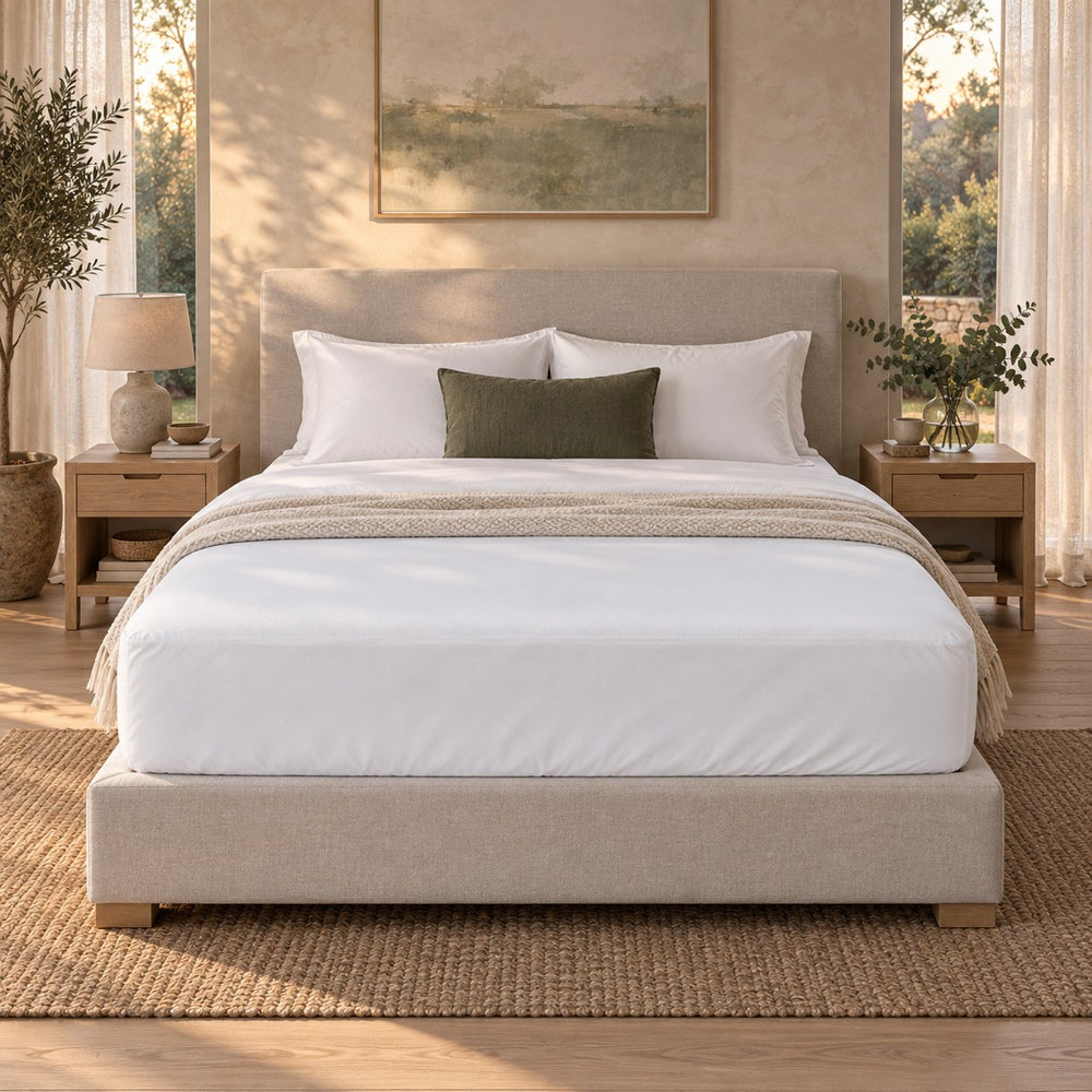 The Huxberry ActivGuard 5-Sided Mattress Protector on a bed, seen straight on from the foot