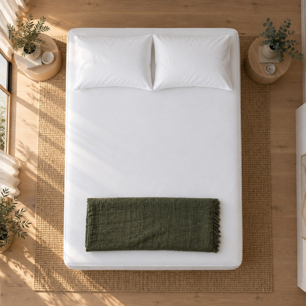 The Huxberry ActivGuard Mattress Encasement from above with a green linen throw