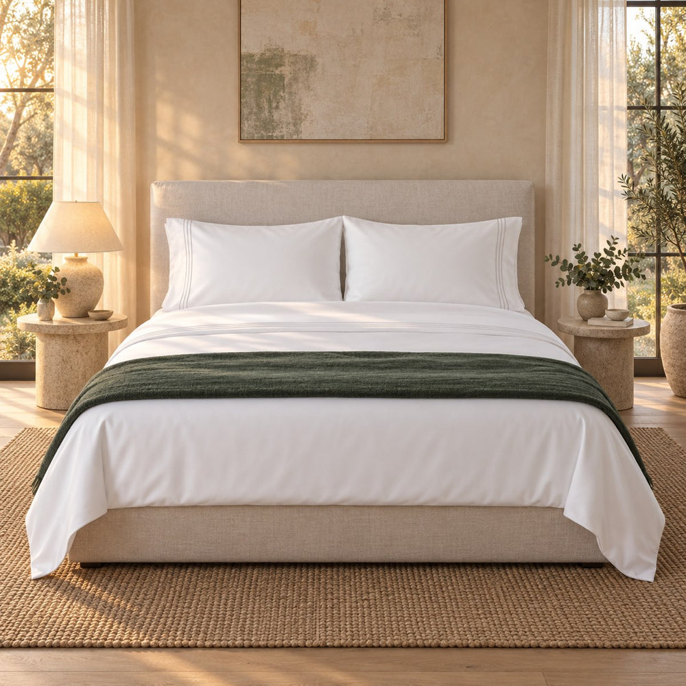 A made bed dressed in the Huxberry Essence Tencel Sheets Set