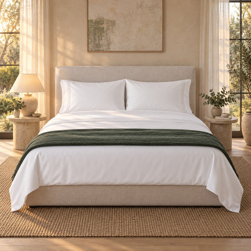 A made bed dressed in the Huxberry Essence Tencel Sheets Set