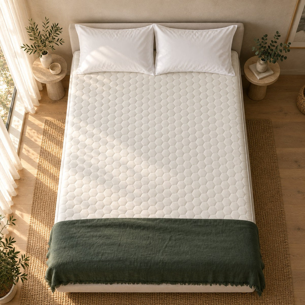 The Huxberry Organic Latex Topper from above with a green linen throw
