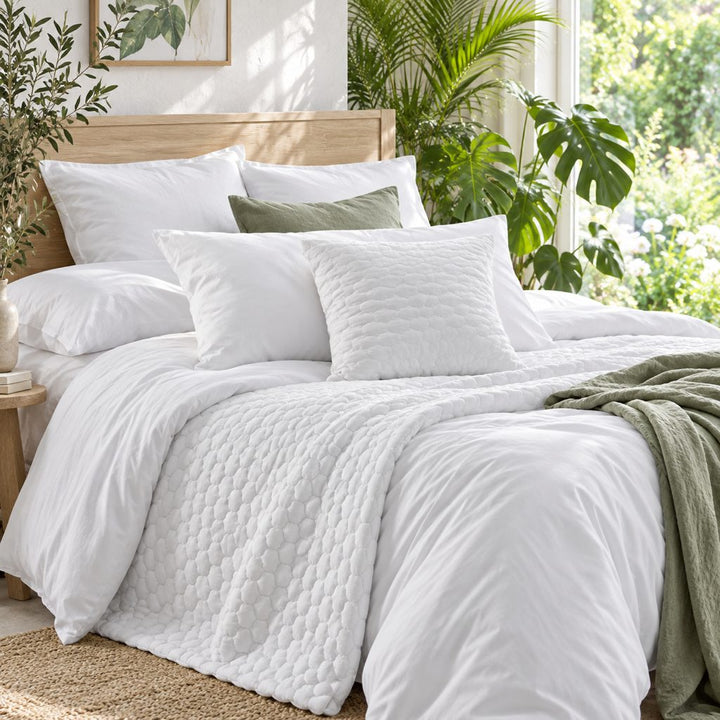 Organic cotton bedding layered on a made bed