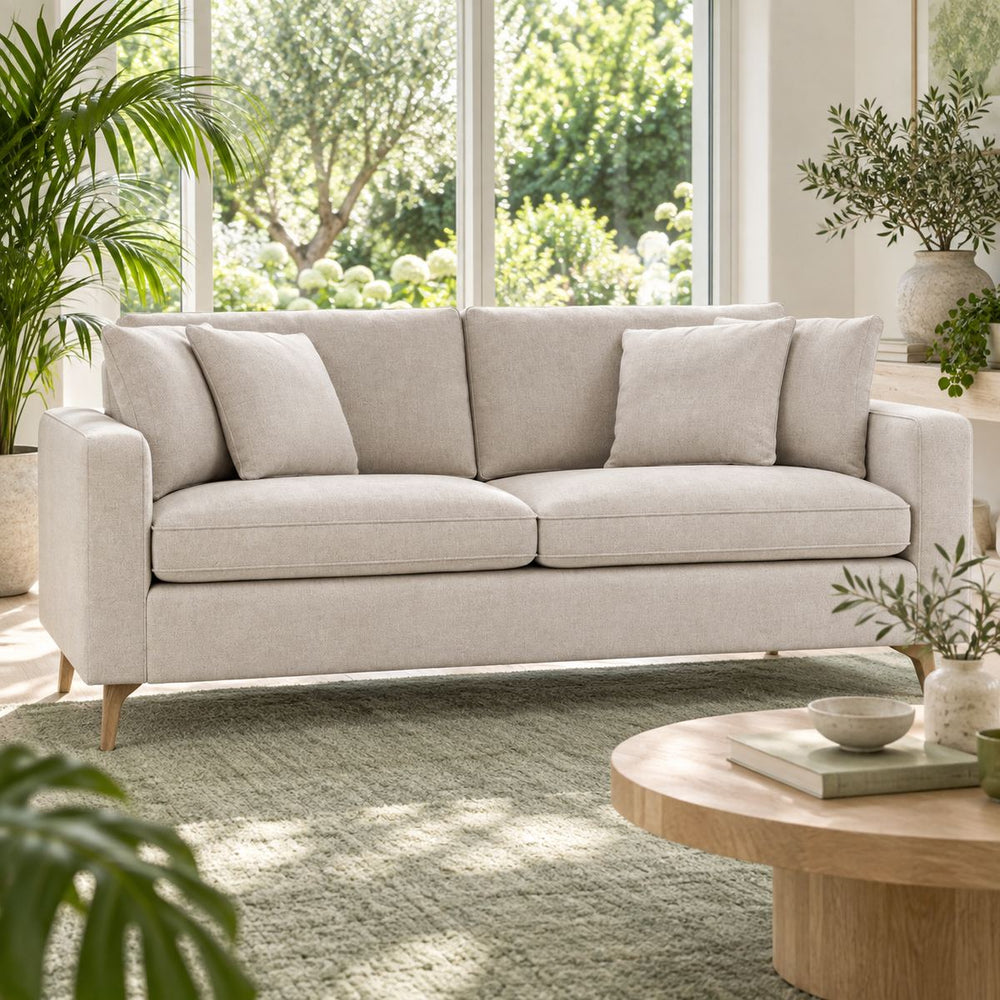 Calvin 2 seater Sofa in a bright, plant-filled living room