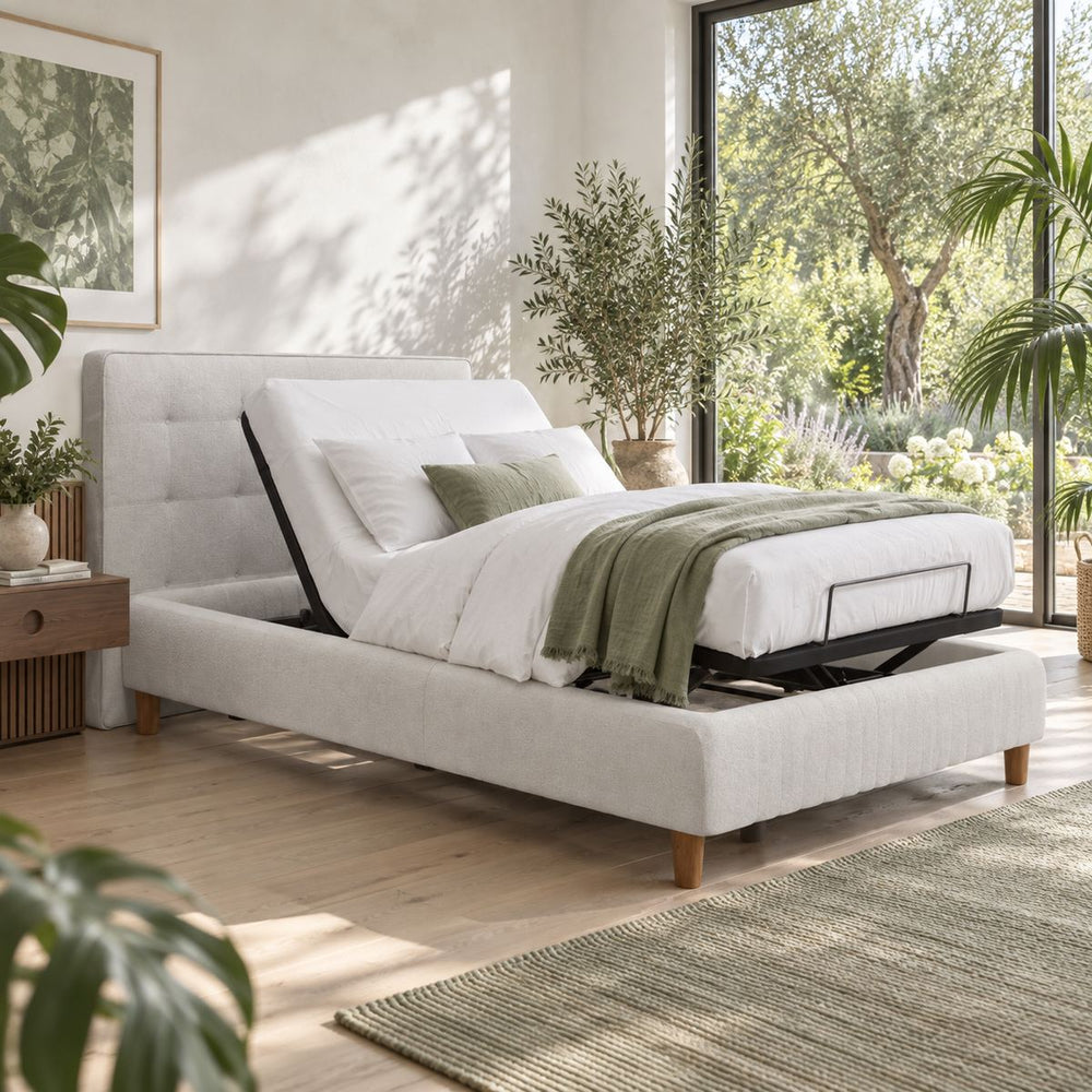 Adjustable Deluxe Bed 180x200 in a bright, plant-filled bedroom